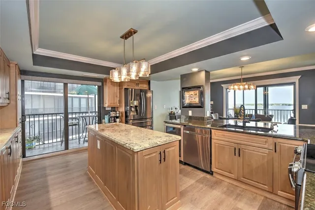 a kitchen with sink stove and refrigerator