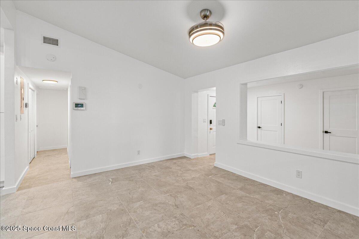 2302 Ruffner Road Melbourne, FL 32901 - Photo 11 of 80 an empty room with a empty space and windows