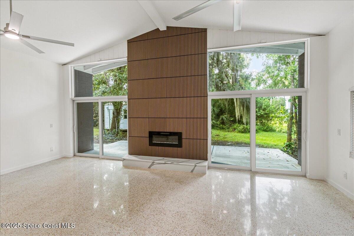 2302 Ruffner Road Melbourne, FL 32901 - Photo 24 of 80 a view of an empty room with a fireplace and a window