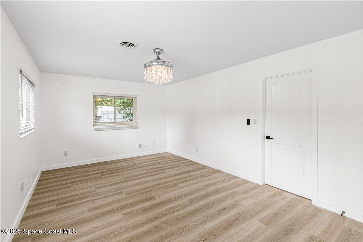 2302 Ruffner Road Melbourne, FL 32901 - Photo 26 of 80 a view of empty room with wooden floor