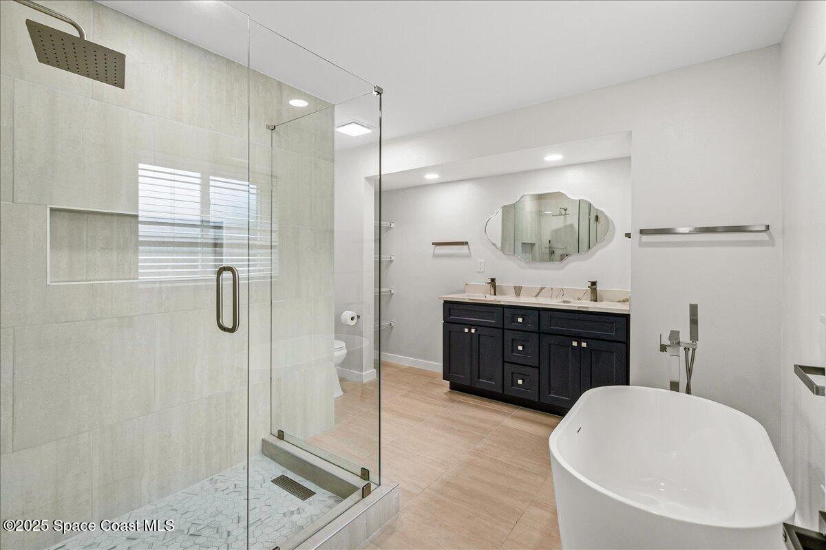 2302 Ruffner Road Melbourne, FL 32901 - Photo 30 of 80 a bathroom with a sink a toilet and shower