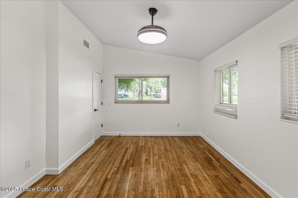 2302 Ruffner Road Melbourne, FL 32901 - Photo 34 of 80 a view of empty room with wooden floor and fan