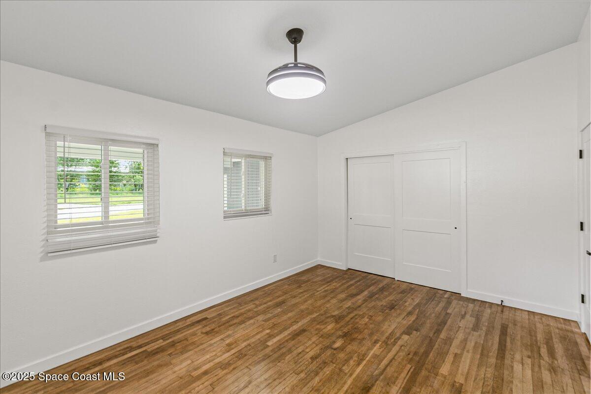 2302 Ruffner Road Melbourne, FL 32901 - Photo 35 of 80 a view of empty room with wooden floor and fan