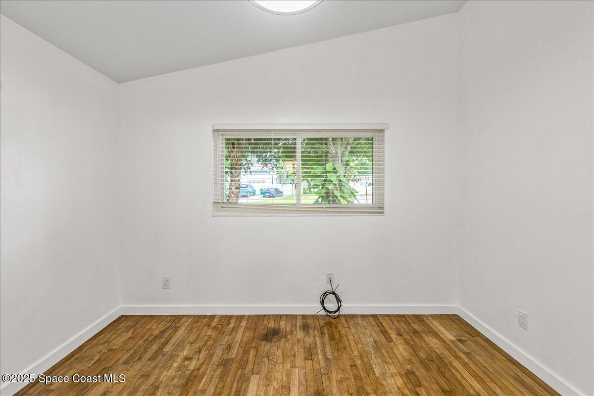 2302 Ruffner Road Melbourne, FL 32901 - Photo 37 of 80 a view of a room with wooden floor and a window