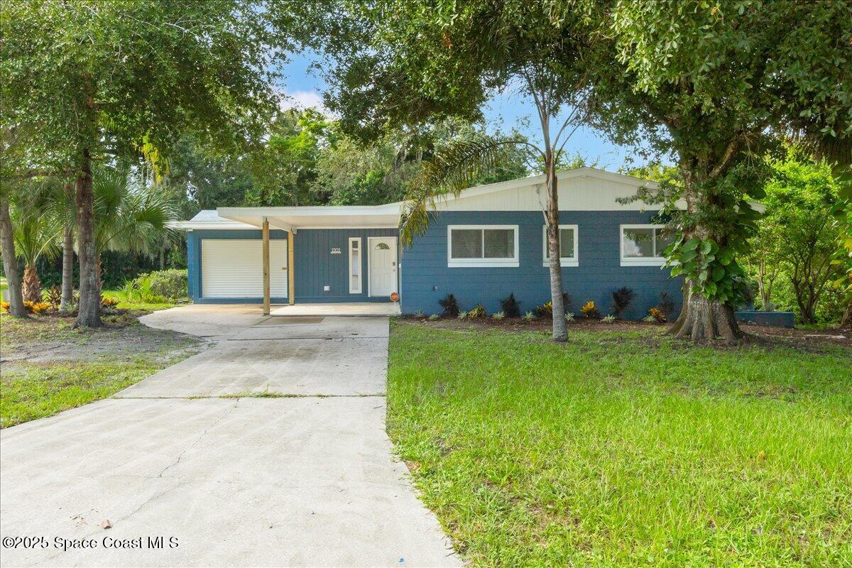 2302 Ruffner Road Melbourne, FL 32901 - Photo 4 of 80 a front view of house with yard and green space