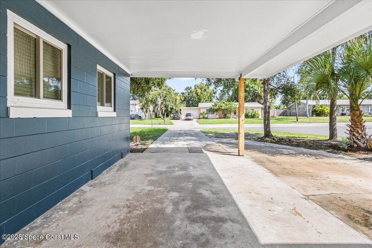2302 Ruffner Road Melbourne, FL 32901 - Photo 45 of 80 a view of a patio with table and chairs next to a yard