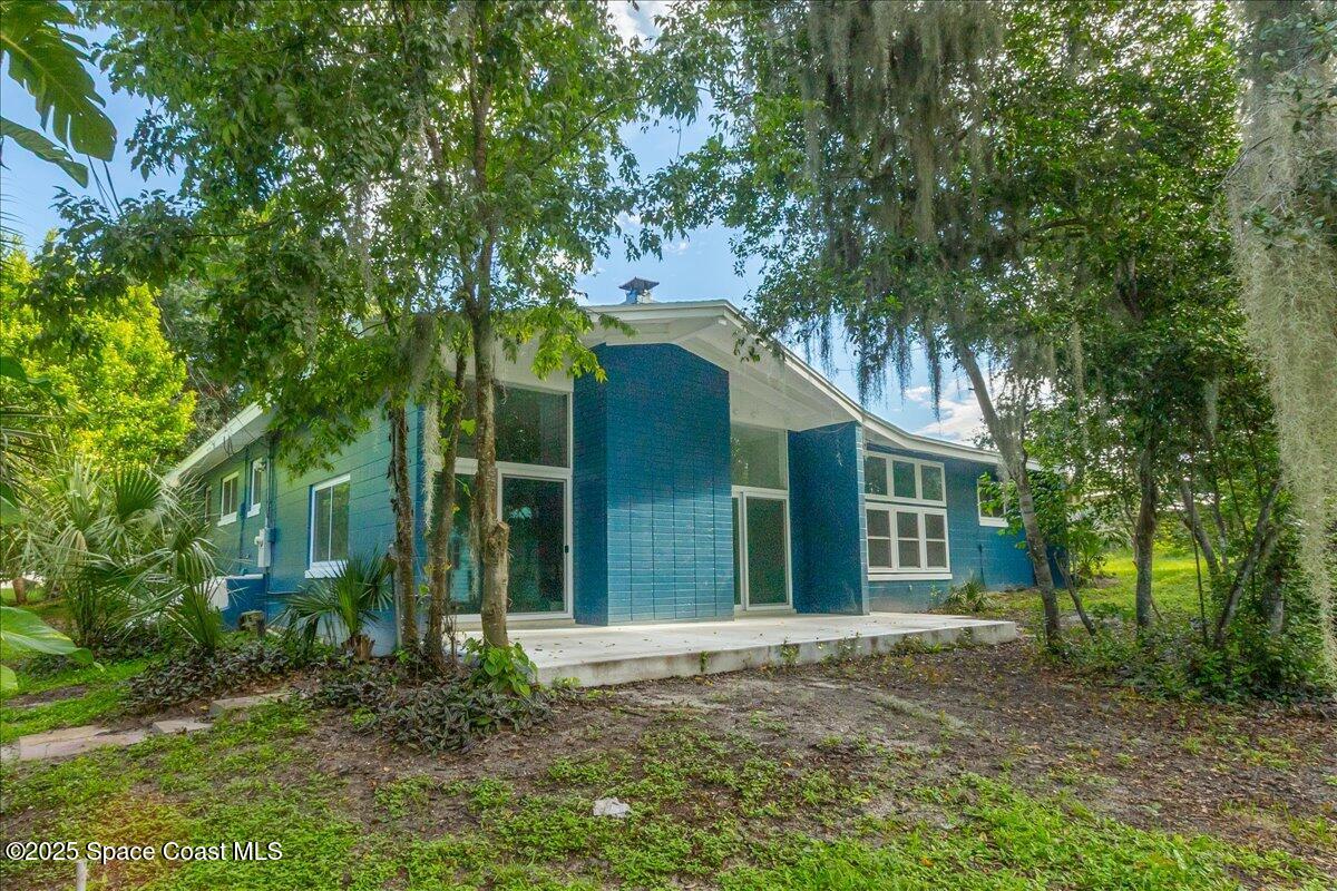 2302 Ruffner Road Melbourne, FL 32901 - Photo 8 of 80 front view of a house with a trees