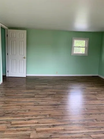 a view of a room with wooden floor