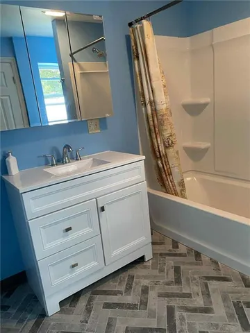 a bathroom with a sink and a mirror