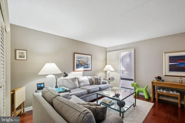 a living room with furniture a lamp and a window