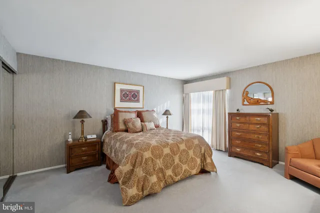 a bedroom with a bed and dresser