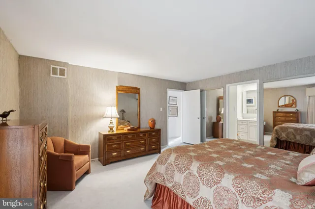 a bedroom with a bed and dresser