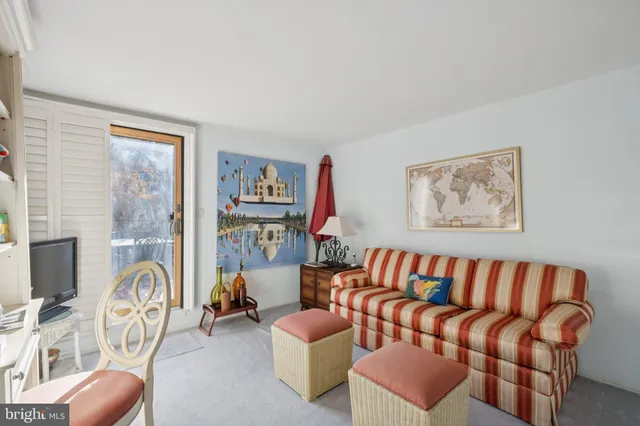a living room with furniture fireplace and a window