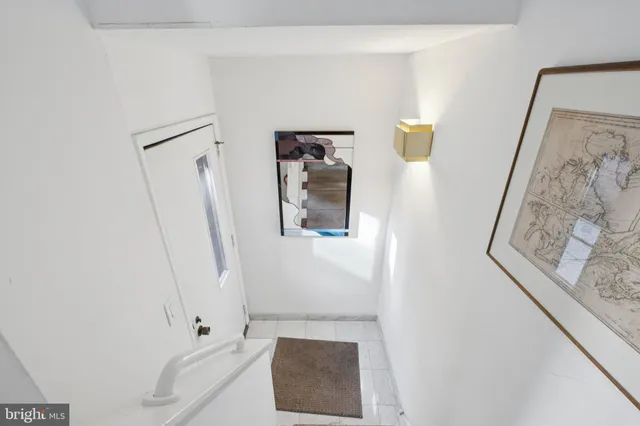 view of a hallway with wooden floor and entryway