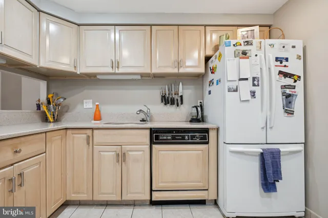a kitchen with stainless steel appliances white cabinets and a refrigerator