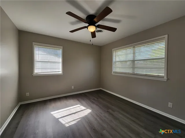a view of wooden floor and windows in a room