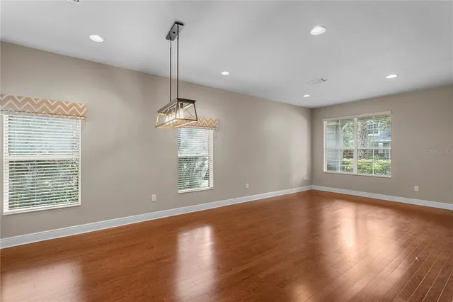 a view of a kitchen with kitchen island a sink dishwasher a stove and a refrigerator with wooden floor