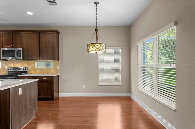 an empty room with a ceiling fan and a window