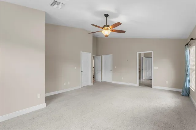 a view of a swimming pool with a table and chairs under an umbrella