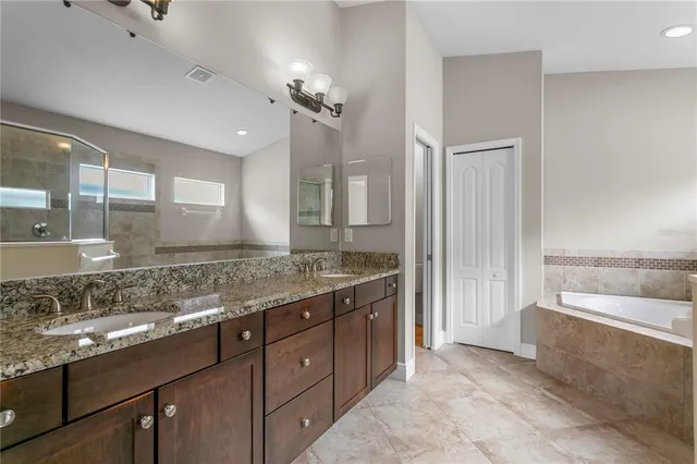 an aerial view of a house with a yard swimming pool and outdoor seating