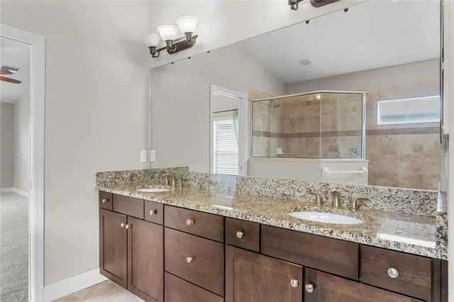 an aerial view of residential houses with outdoor space and trees