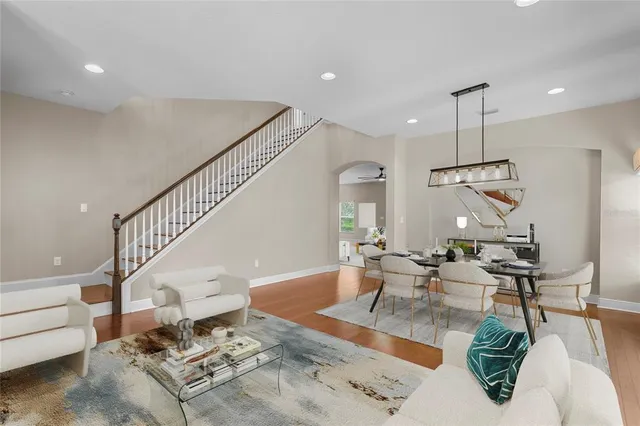 a living room with furniture a window and a dining table