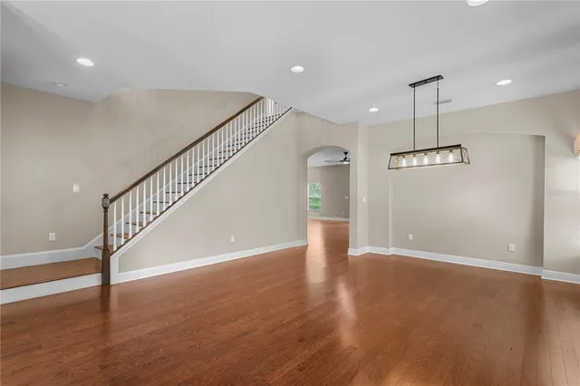 a view of empty room with wooden floor and outdoor window