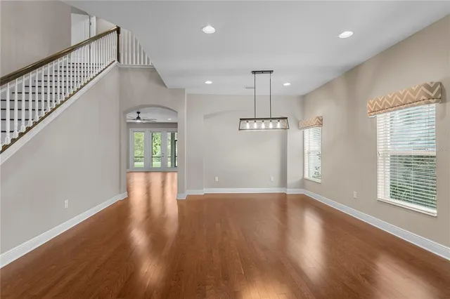 a view of a livingroom with a ceiling fan and wooden floor