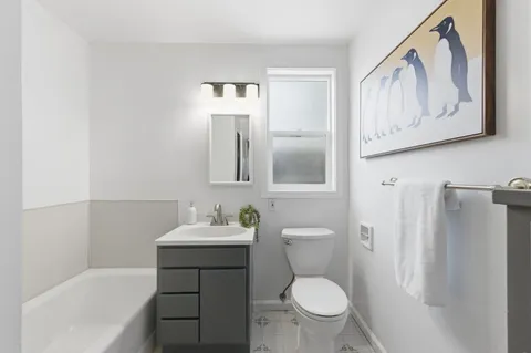 a bathroom with a sink toilet and mirror