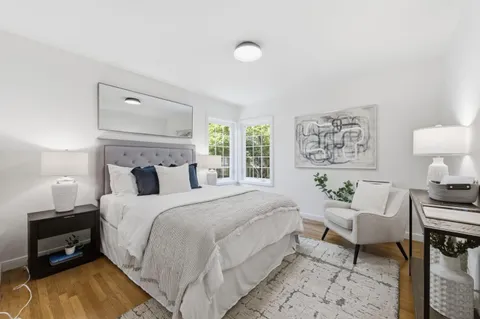 a bedroom with a bed and a lamp on table