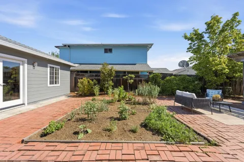 a view of a backyard with sitting area