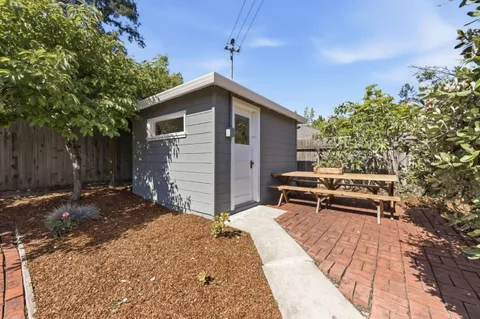 a view of a backyard with sitting area