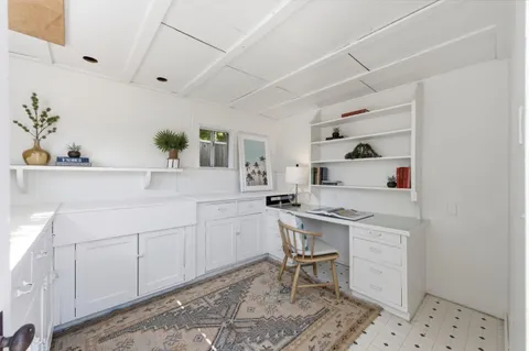 a room with a sink and cabinets