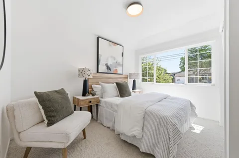 a bedroom with a bed and window