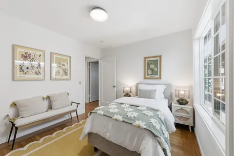 a bedroom with a bed and a couch