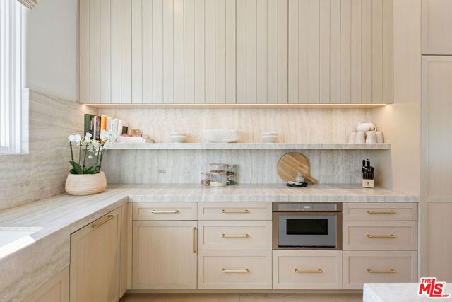 a kitchen with white cabinets and white appliances
