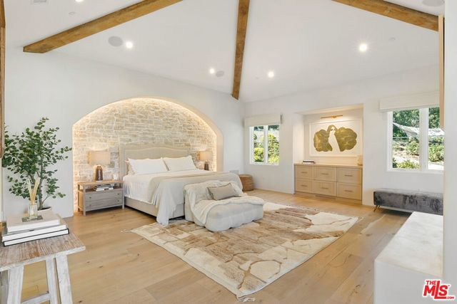 a spacious bedroom with a large bed and a couch