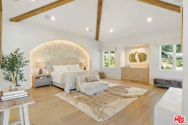 a spacious bedroom with a large bed and a couch