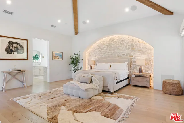 a bedroom with a large bed and a couch