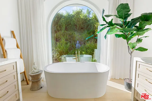 a white bath tub sitting in a bathroom