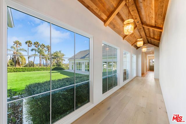 a view of a house with a big yard and potted plants