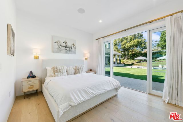 a bedroom with a bed and a large window