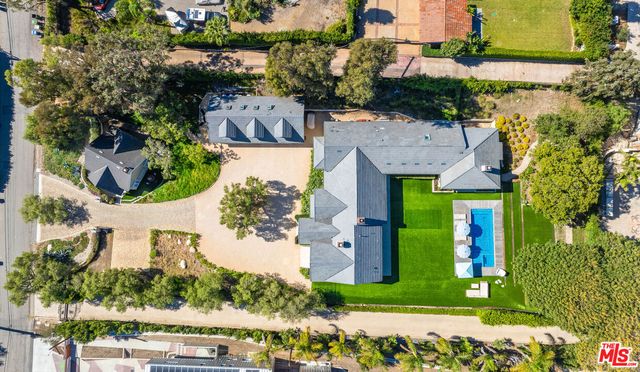 a dining room with a wooden table and chairs