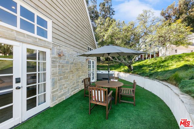 a bedroom with a bed and large window
