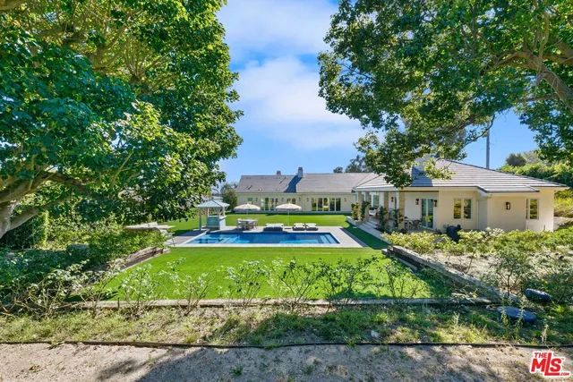 a front view of a house with a yard table and chairs