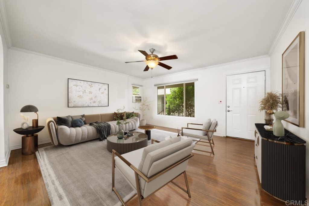 a living room with furniture and wooden floor