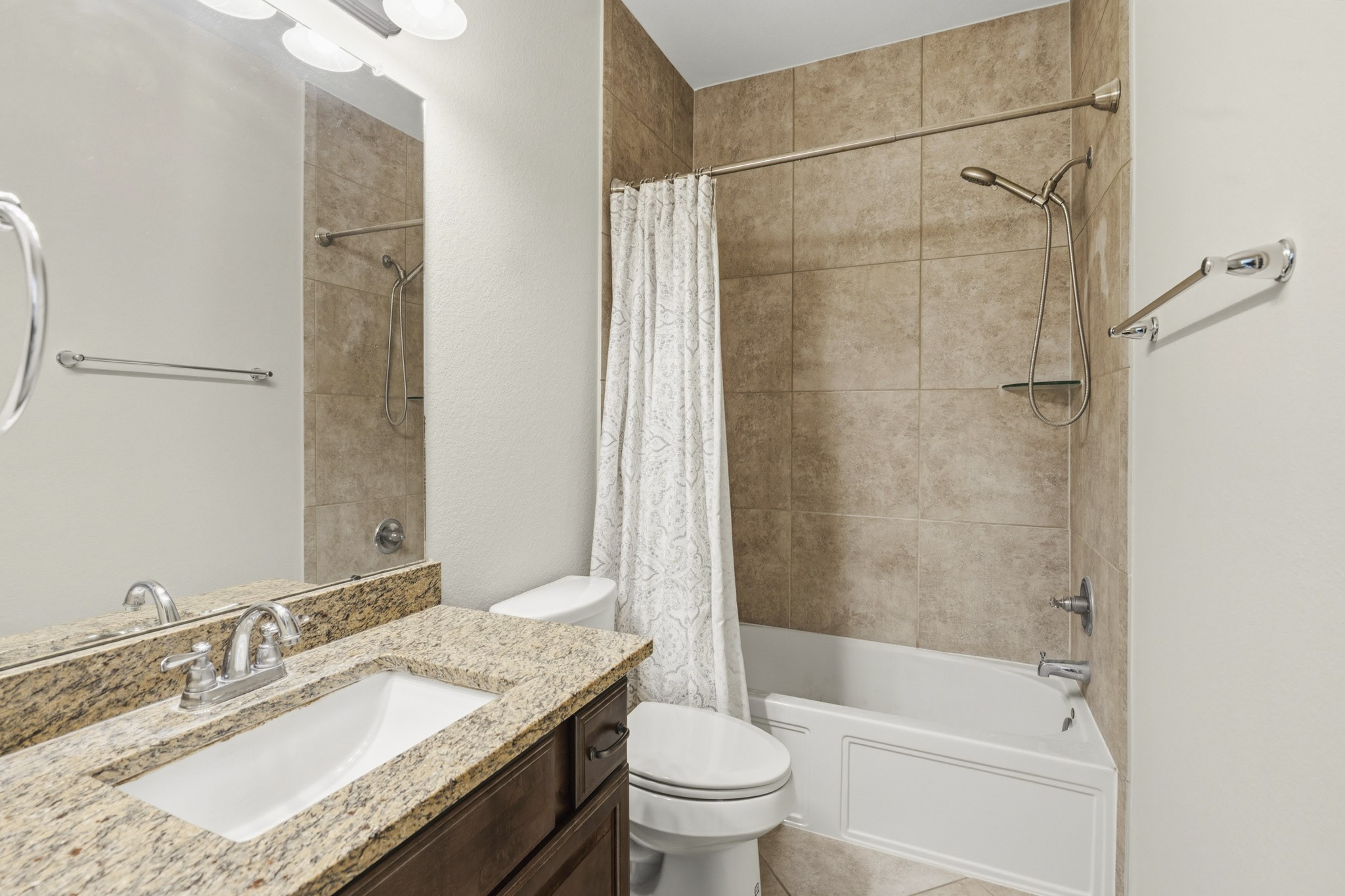 12115 San Luca Street Richmond, TX 77406 - Photo 29 of 44 Featuring granite countertops and tile-surround tub and shower, this well-appointed bathroom provides both comfort and style for family members or overnight guests.