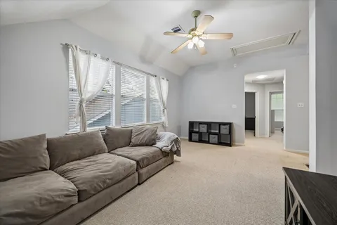 a living room with furniture and a large window