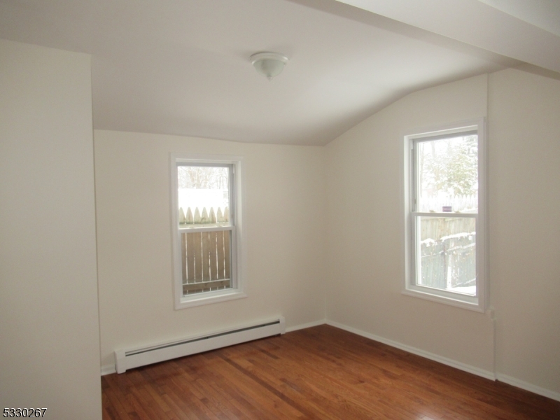 10 Humbert Street Nutley, NJ 07110 - Photo 12 of 16 a view of an empty room with wooden floor and a window