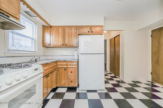 a kitchen with a refrigerator a stove and a sink